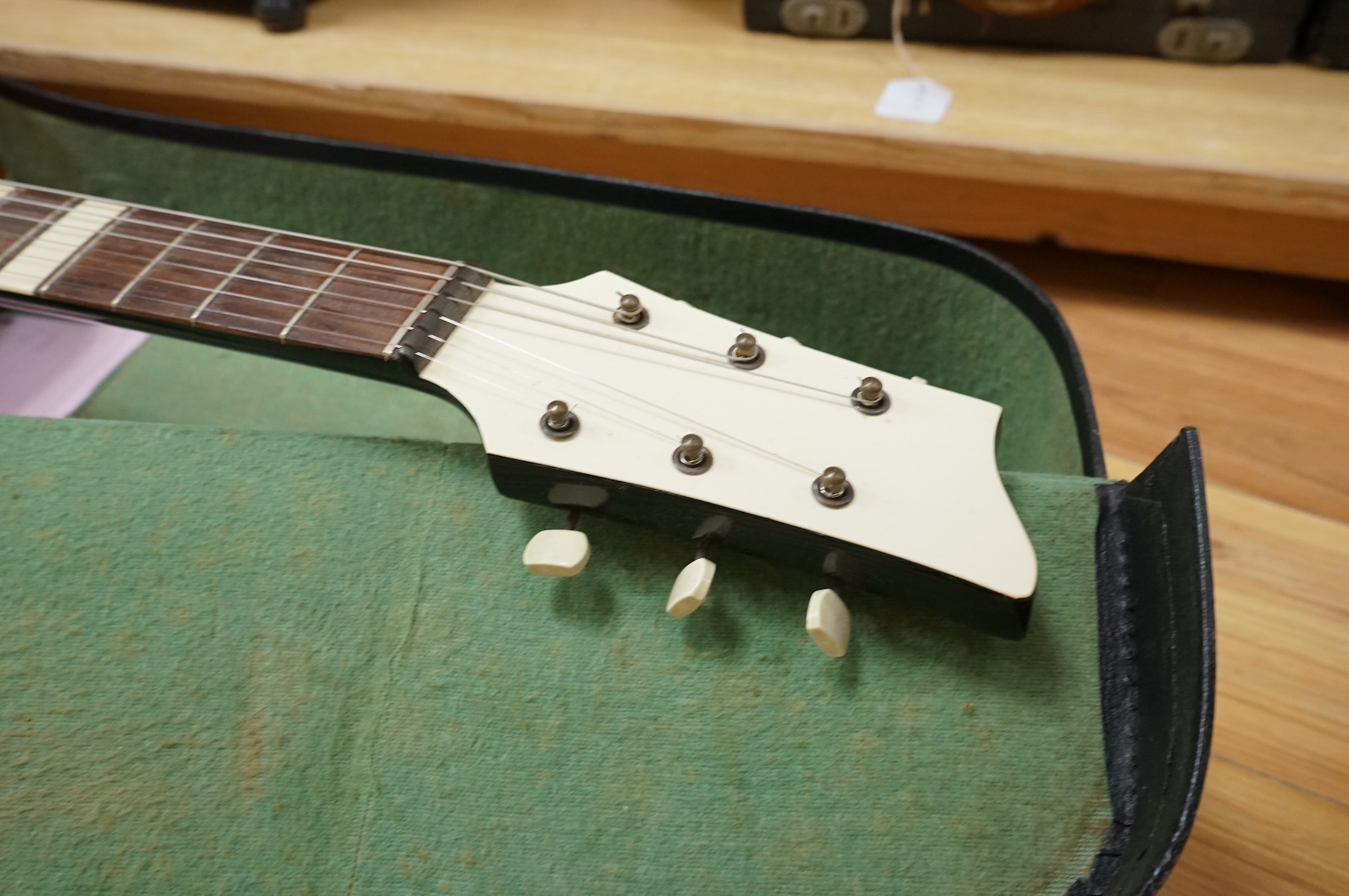 A 1950's Hofner style cut-away acoustic guitar, fitted with a pick up bearing Hofner engraved signature, with hard case.